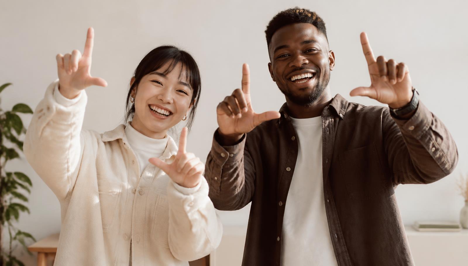 Two colleagues raising their hands in the lalalab L shape